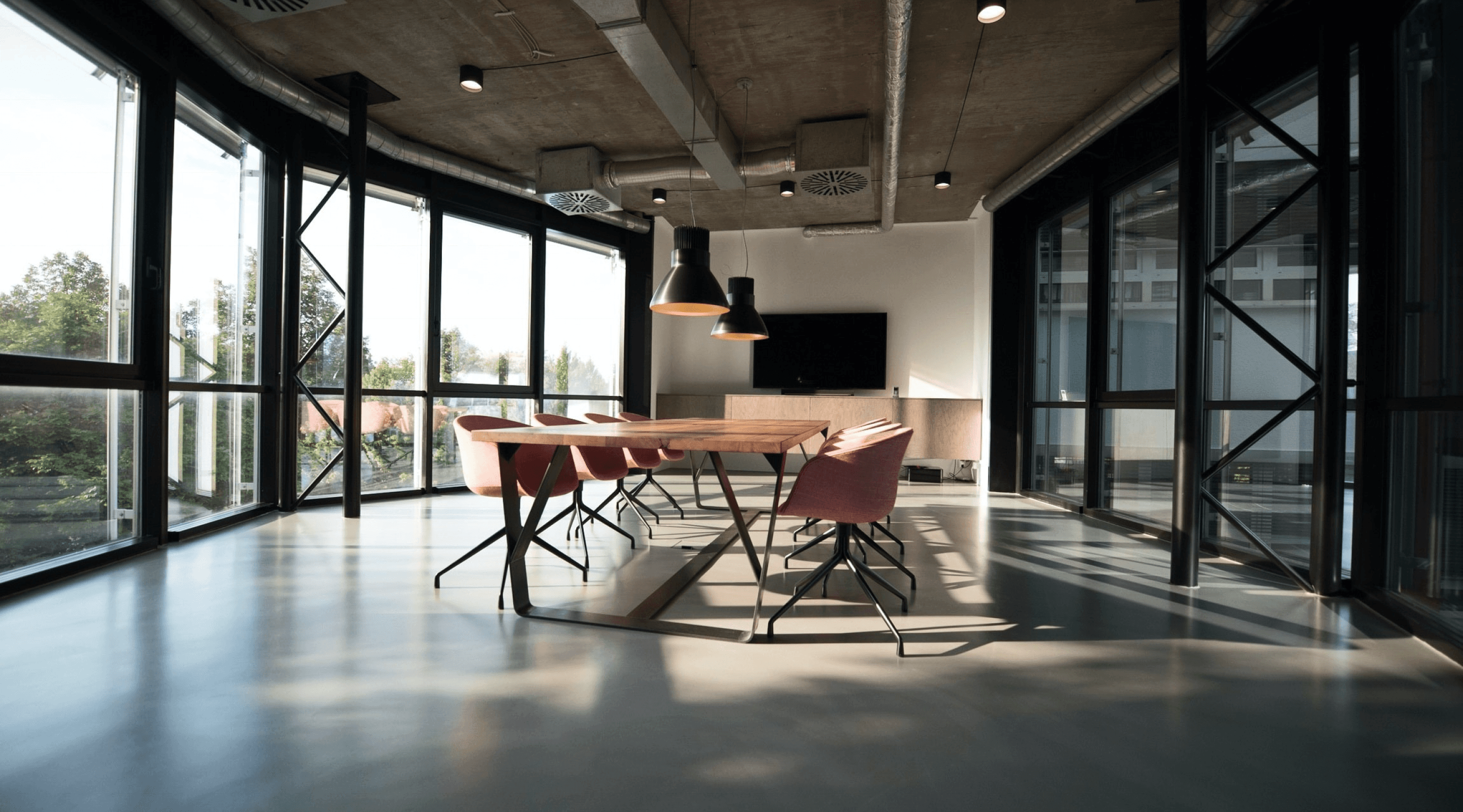 An image of office room with a room with a table and chairs